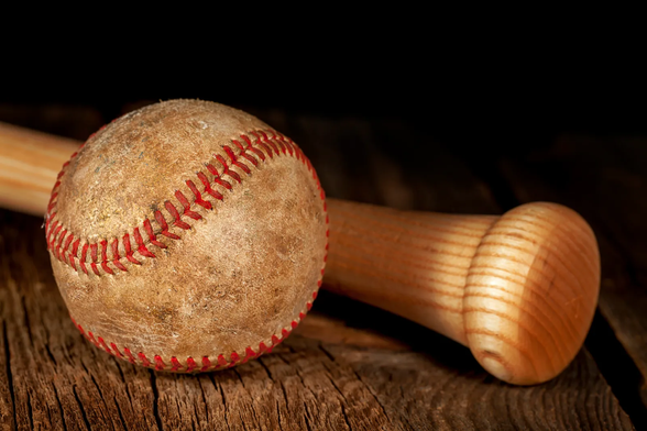 A game worn baseball and bat, representing my love for the game of baseball