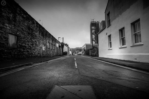 Monochrome low angle shot along empty side street