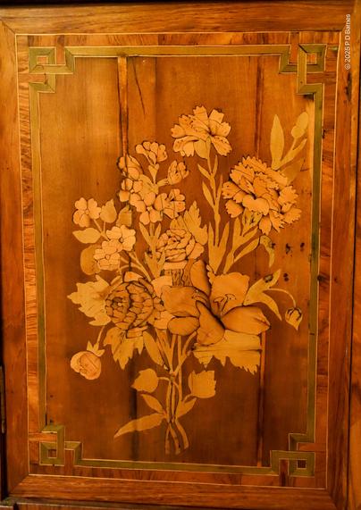 A detailed and complex timber inlay of a floral bouquet.