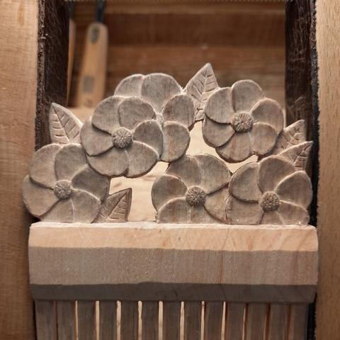 A closeup of the carved motif without paint.