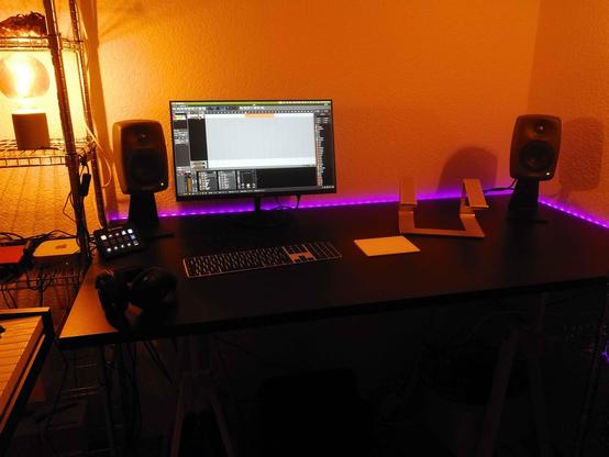 Table, my view. Ready for synths and stuff. Pink LED strip in the back, warm light, black table.