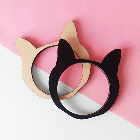 Lasercut cat shaped bracelets made out of wood and matte black acrylic