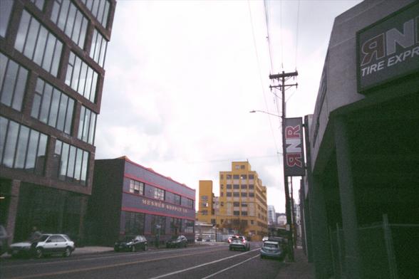 A photo of a street lined with old buildings in an industrial area of Portland, Oregon.
