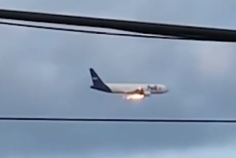 Blurry photo of a FedEx plane showing an engine on fire