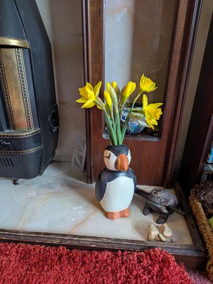 puffin vase with daffs in
