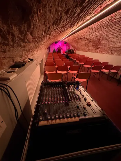 A small venue with mixing desk in front of it