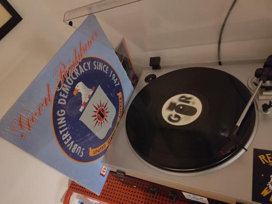 record player playing Good Riddance - Operation Phoenix LP, on the left is  the cover