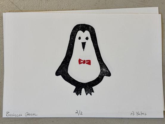 A block print of a little penguin wearing a jaunty red bow tie.