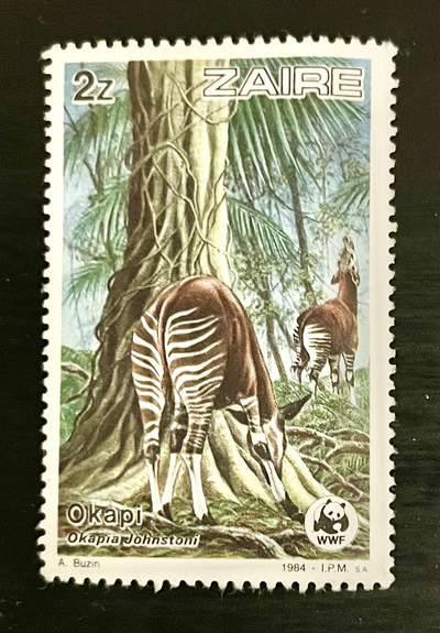 An old “Zaïre” (DR Congo) postage stamp with two okapi in a forest. There’s a WWF logo in the lower right corner.