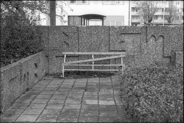 Black and white photographs of an outdated park. A picnic table can be seen. A few concrete sculptures can also be seen.