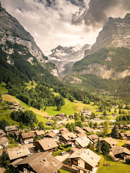 Houses dot the lower third of the photo with mountainous layers filling the upper two thirds.