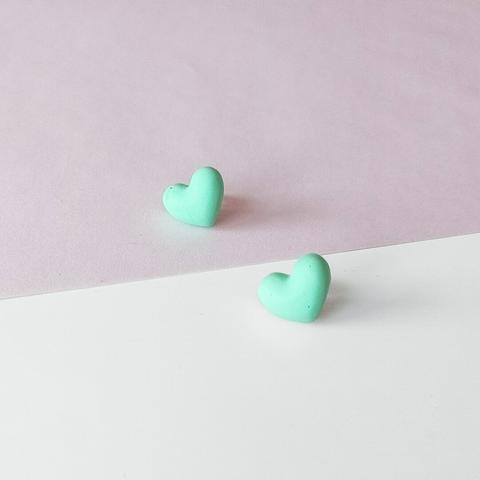 mint green ear studs in the shape of hearts