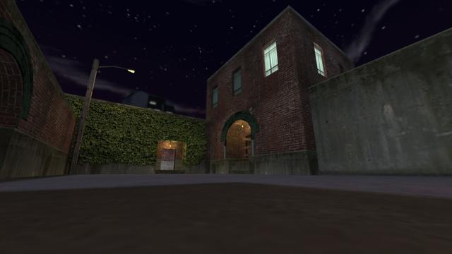 In this picture you can see the opposite side of the red brick building. You can see a red brick building again. However, this is smaller. The entrance goes slightly into the buildin and up a small staircase. In the enterancr is an illuminated yellow lamp. The door is nailed shut with wooden boards. The windows of this building have no bars. A light is burning in one room. To the right of the building is a concrete wall. On the left you can see an entrance to an even smaller red brick building, which is completely wrapped in ivy. This entrance also goes a little into the building and also has a yellow illuminated lamp. You can just walk in here as there is no door. In front of this is the lamp attached to the wooden pole. Further to the left is the wall with the passage, which can be seen on the left edge of the picture. This is on the map cs_backalley in the game Counter-Strike 1.6.