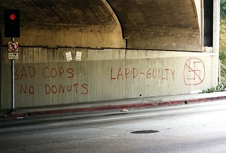 Graffiti on a concrete wall in Los Angeles, during the riots, that reads: Bad Cops, No Donuts. LAPD-GUILTY