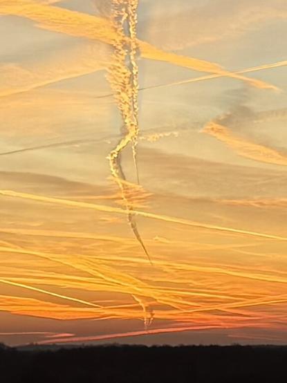 A zoomed in version of the first image, concentrating on the zigzaging contrails near the horizon.