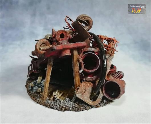 The pile of rusty metal is held up by wooden posts.