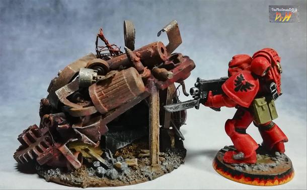 Under the junk pile is a camp for one with bedding and campfire. Space marine for scale.