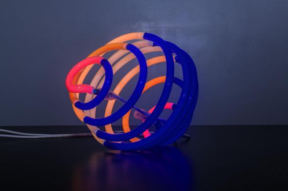 The darker cobalt side of the eclipse sphere, with pink tips of the light side visible