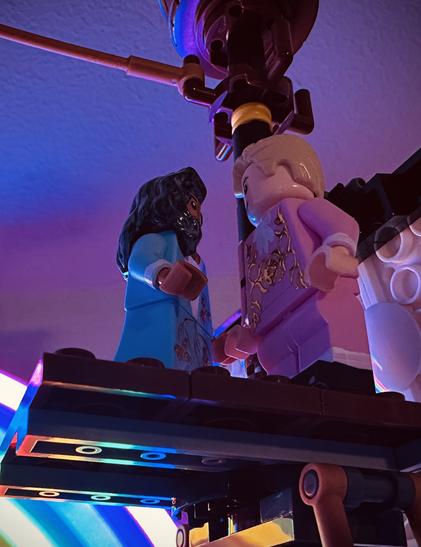 Lego Ed in his blue dress and Lego Stede in his pink suit look lovingly at one another