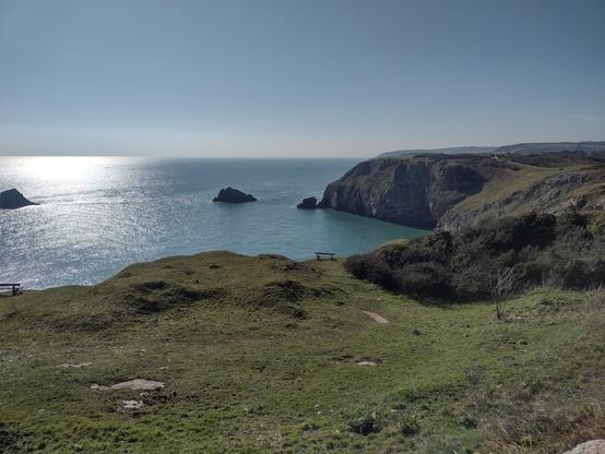 Looking out from Berry Head at the calm sea and rugged coastline. Steep cliffs and small islands can be seen and the sounds of the bird life that inhabits them could be heard.