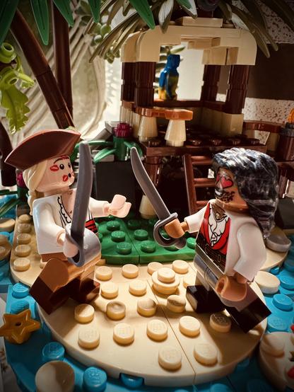 Lego Ed and Lego Stede in ridiculous pirate costumes, sword fighting on a beach.