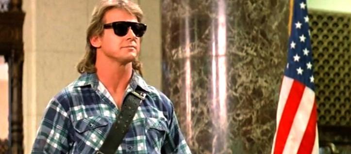 Actor Roddy Piper, with long blond hair and sunglasses, delivering his famous dialogue in John Carpenters 'They Live'.