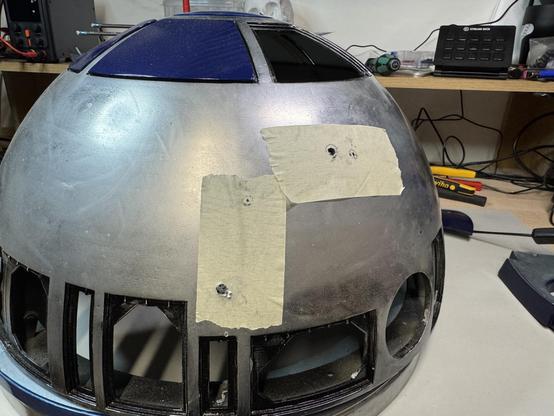 The dome of Artoo, with two pieces of tape on it, for better marking of the drill holes.