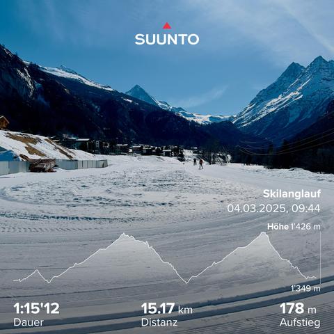Slopes for cross-country skiing in the Swiss Alps on a sunny day. High snow covered mountains in the background.