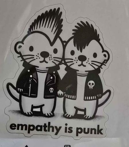 sticker with two cute comic style otters, dressed like punks, holding hands. Text: empathy is punk