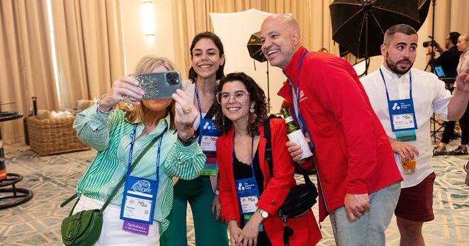 Photo of a group of smiling people taking a selfie at the Agile20XX conference.