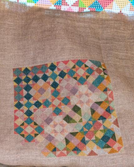 Unfinished cross stitch project, geometric colorful shapes.