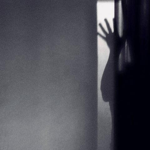 HEFT - Ombre cover artwork. Monochrome shaded shot of a wall, shadow of a person, hand up.