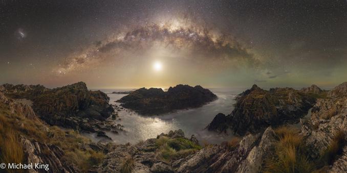 The Milky Way with the setting moon over the rugged coastline at Sarah Ann Rocks