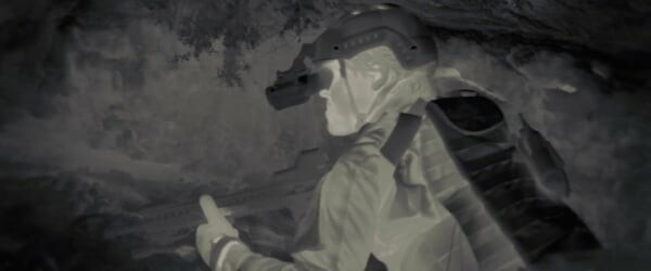 A still from Sicario showing a soldier in infra-red. His face is bright white, but his night-vision goggles and body armour are almost black.
