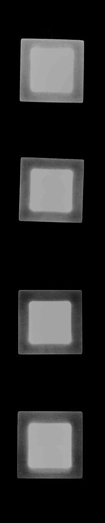 Four rectangular shapes arranged vertically against a black background. Each rectangle has a lighter inner area with a darker border, and they appear to be slightly tilted at different angles. The inner areas have varying levels of brightness.
