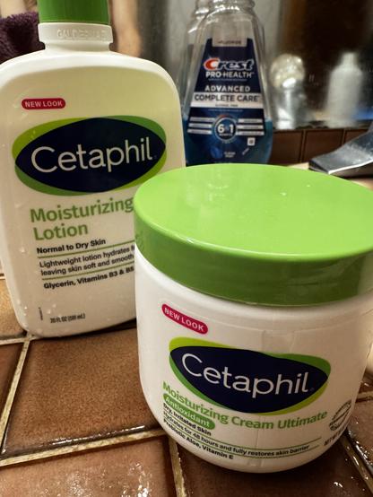 A jar and a pump container of Cetaphil moisturizing products, Canadian made, sitting on a bathroom counter.