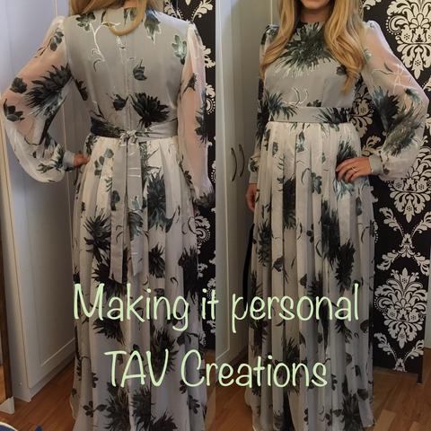 Floral print chiffon dress with back and front view. A blonde woman stands in front of a black and white motif screen and white cupboard.
Sheer sleeves and fully lined body, with simple dart shaping on the bodice and generous pleats on the skirt. A wide sash completes the look with cuffs on the gently gathered sleeves matching. 
Text on photo: making it personal TAV Creations