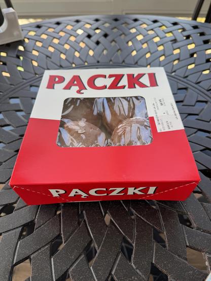 A red and white box of these extra-special, extra-rich filled donuts sit on a metal trellis table.  The plastic window shows 4 of the goodies inside (which was not true for long.)

I believe these are Polish, and the ones we hold out for are filled with Bavarian Creme, although one can find them with lemon or raspberry as well.