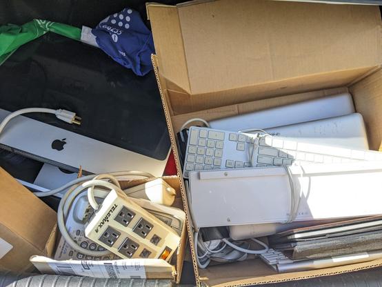 In the trunk of a car is the haul from trashnothing: an iMac, an iPad, multiple MacPro's, keyboards, and some various ewaste.