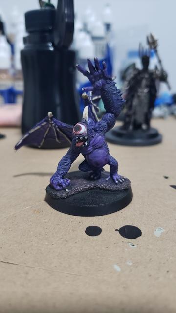 Reaper miniatures bones ape demon with a head conversion to make it a cyclops with a horn growing out of it head. It is now painted purple with the wing bones painted with a yellow bone color that matches the horn.