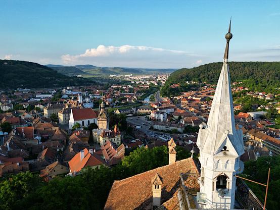 aerial view on a city in the valley done from the tower of a Chapel