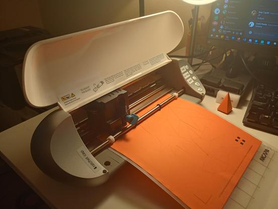 a cutting robot, cutting out several copies of the pyramid pattern.