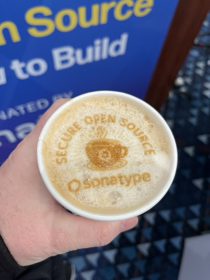 A latte with the Sonatype logo in the foam