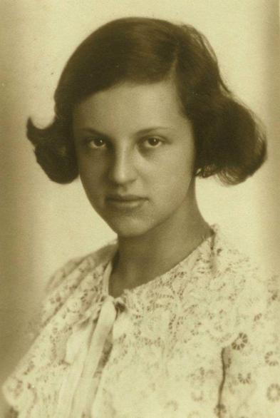 Vintage sepia-toned portrait of a girl with a serious expression, wearing a lace collar.