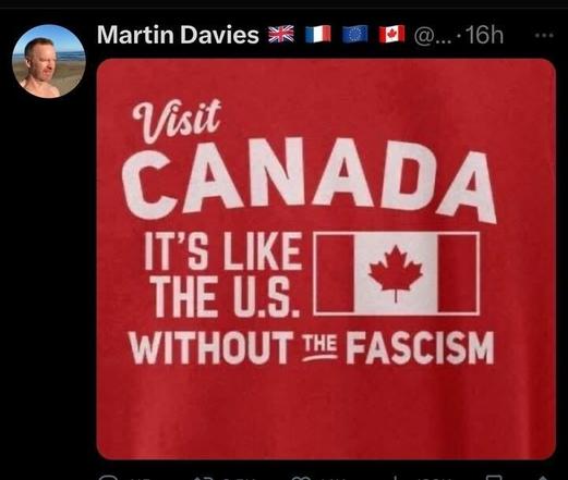A tweet from Martin Davies @..., posted 16 hours ago, featuring an image of a red T-shirt with the text 'Visit CANADA IT'S LIKE THE U.S. WITHOUT THE FASCISM' and the Canadian flag. The tweet includes flags of the UK, France, and the EU next to the user's name.