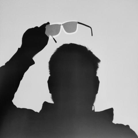 Shadow of me in front of a beamer. The projectors LCD pixels are visible by the distortion of light through glasses