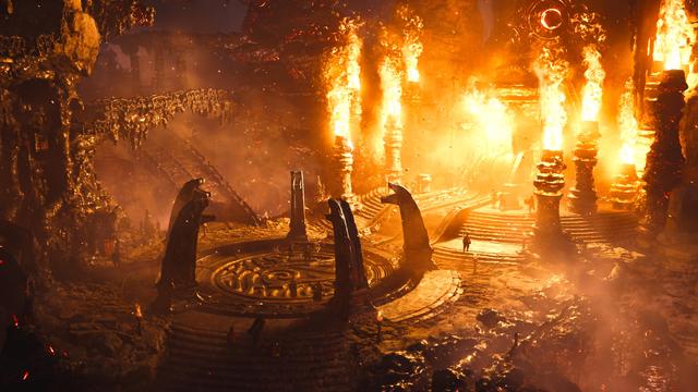 A high-fantasy medieval forge , with pillars of fire, inside a bolcano, like a bird view shot. Everything is bright red and reflected on the black stone structures