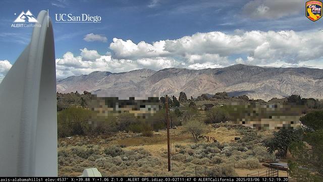 This ALERT California image from the Alabama Hills area (near Lone Pine) shows a blue sky with a well-developed set of white clouds. Infrastructure from the camera site (left) along with privacy pixelation (middle ground) are also found in the image. The hills and vegetation are a beautiful reason to visit.