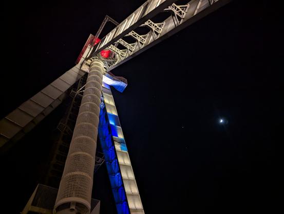 A large building to do with mining is lit dramatically at night.