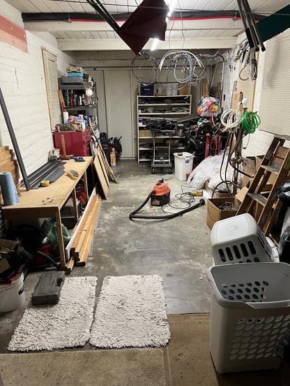 A garage partially cleaned/organized to accommodate a restore automobile